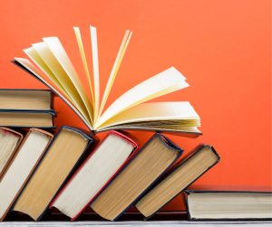 Picture of books lined up and leaning to the side